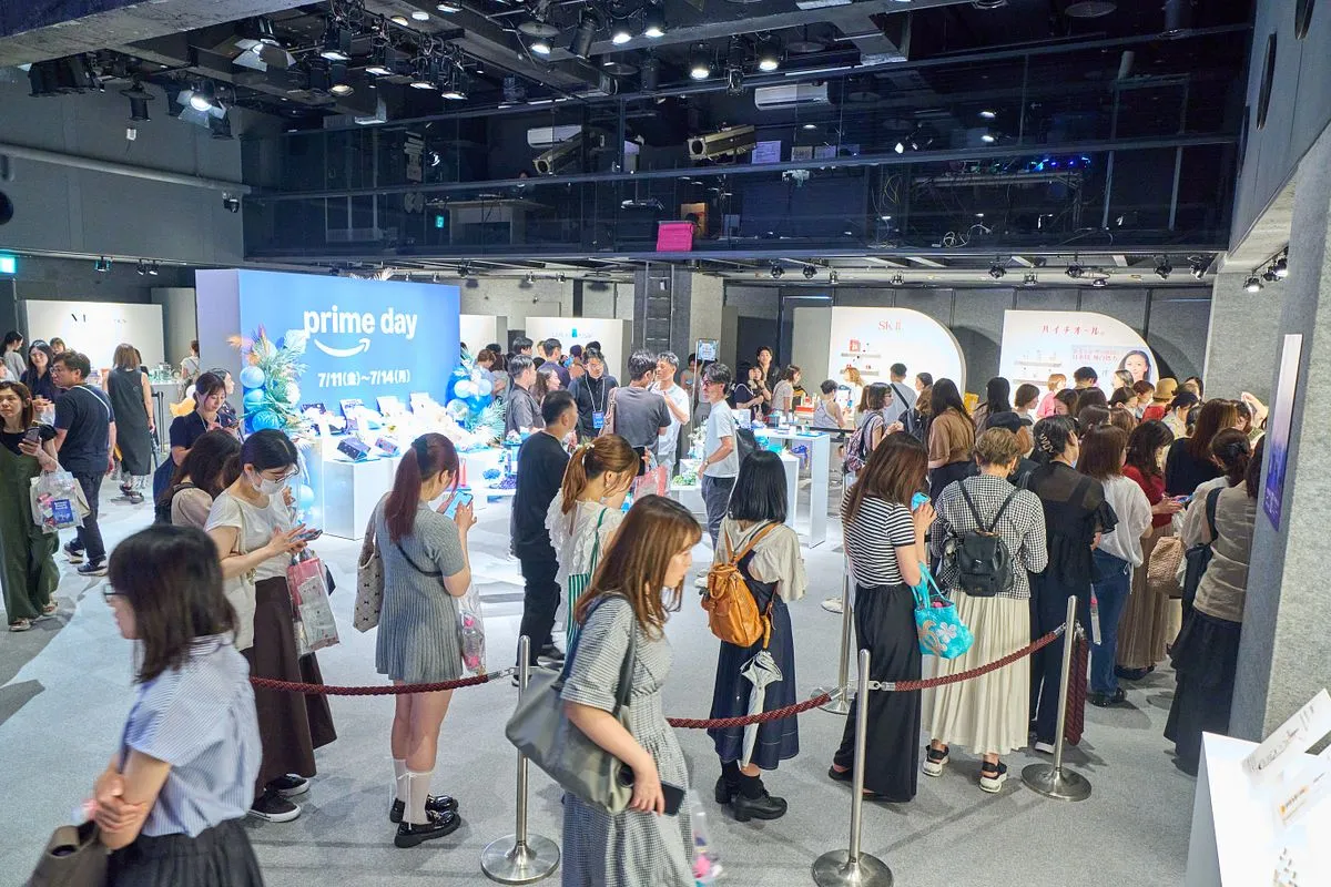 A crowd of guests moving between brand booths at Laforet Harajuku, with Kérastase and Amazon Beauty Festival signs.
